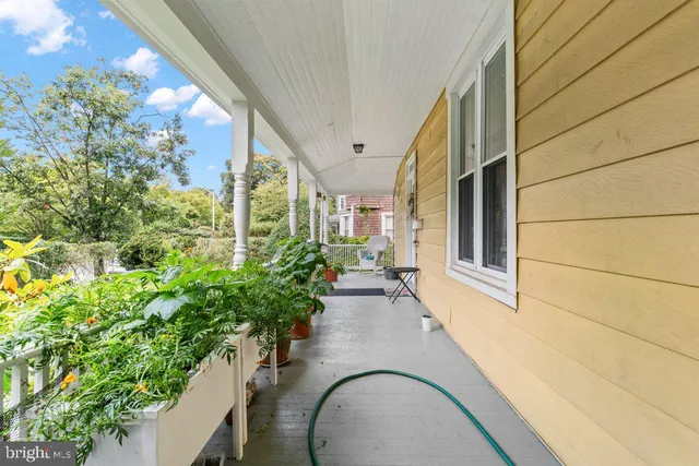 a very nice looking house with potted plants