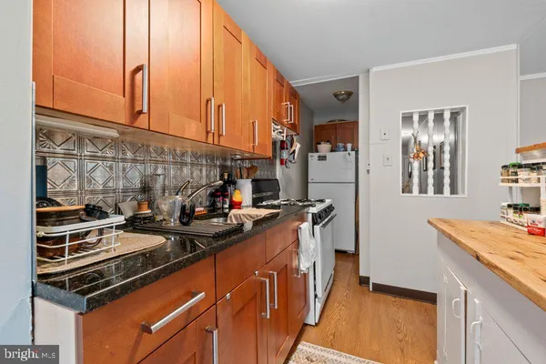 a kitchen with stainless steel appliances a stove a sink and a refrigerator