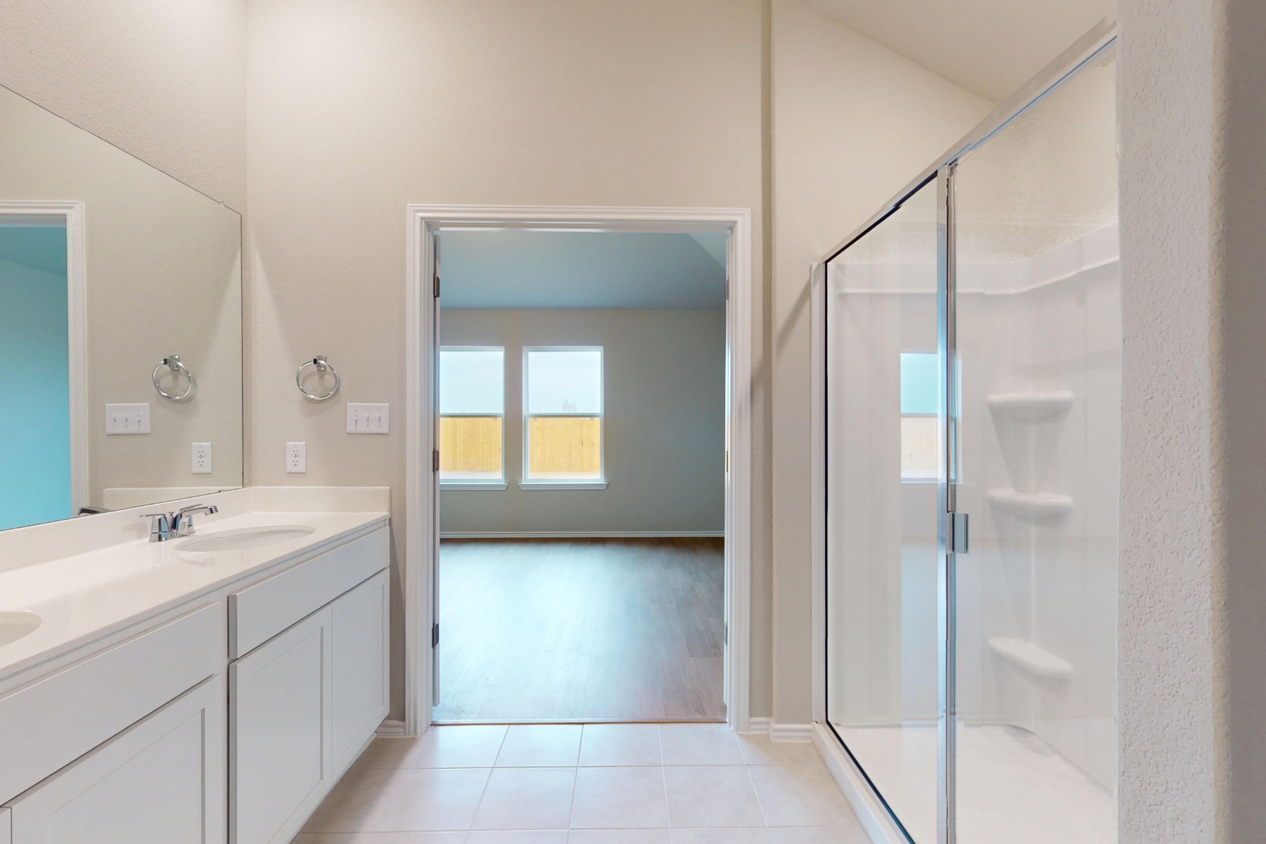 20017 Schatz Way Manor, TX 78653 - Photo 14 of 34 a bathroom with a double vanity sink and a mirror
