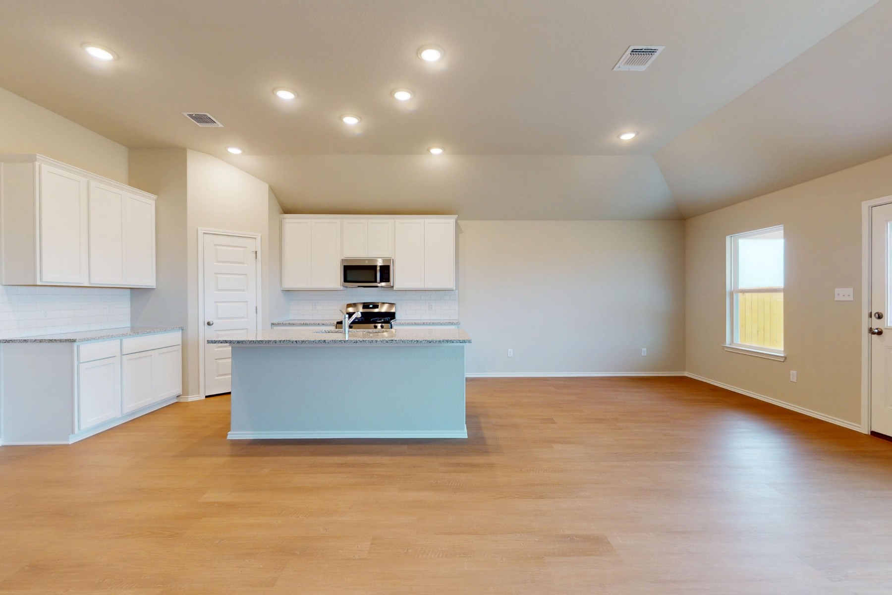 20017 Schatz Way Manor, TX 78653 - Photo 3 of 34 a view of kitchen with kitchen island a sink wooden floor and counter top space