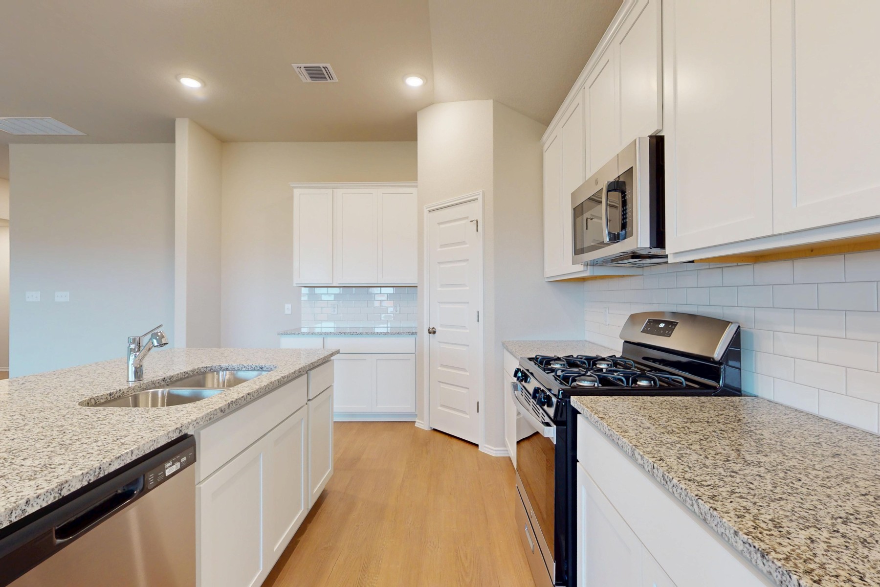 20017 Schatz Way Manor, TX 78653 - Photo 5 of 34 a kitchen that has a sink and a stove