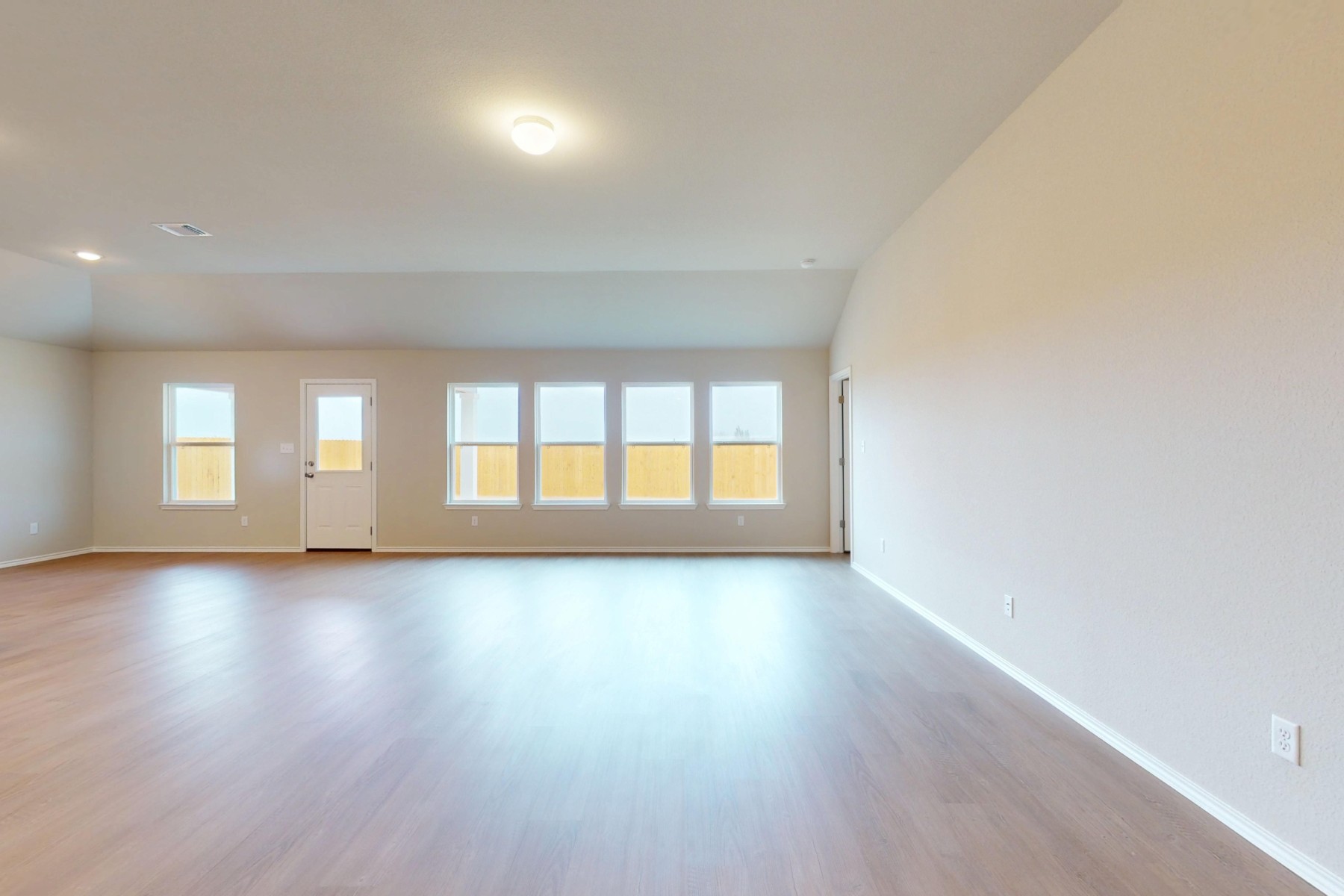 20017 Schatz Way Manor, TX 78653 - Photo 8 of 34 an empty room with wooden floor and windows