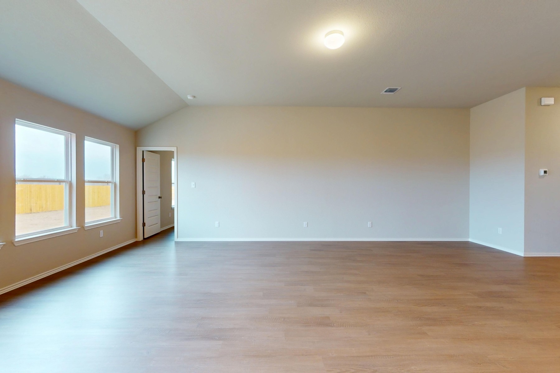 20017 Schatz Way Manor, TX 78653 - Photo 10 of 34 an empty room with wooden floor and windows