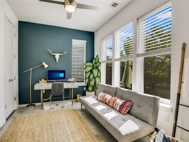 a living room with furniture and a large window