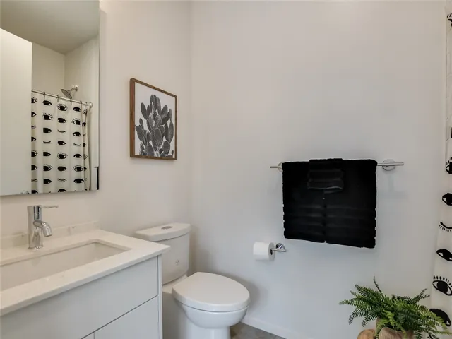 a bathroom with a toilet a sink and a mirror