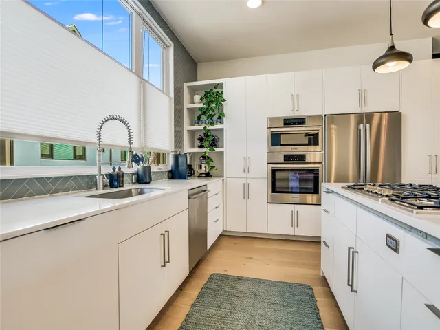 a kitchen with refrigerator and cabinets