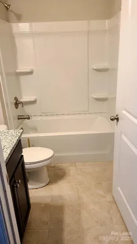a bathroom with a toilet a sink a vanity and mirror