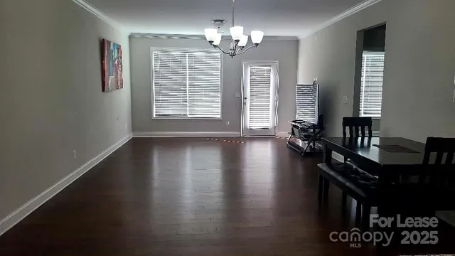 a view of a livingroom with furniture window and wooden floor