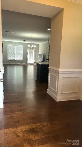 a view of a living room with hardwood floor