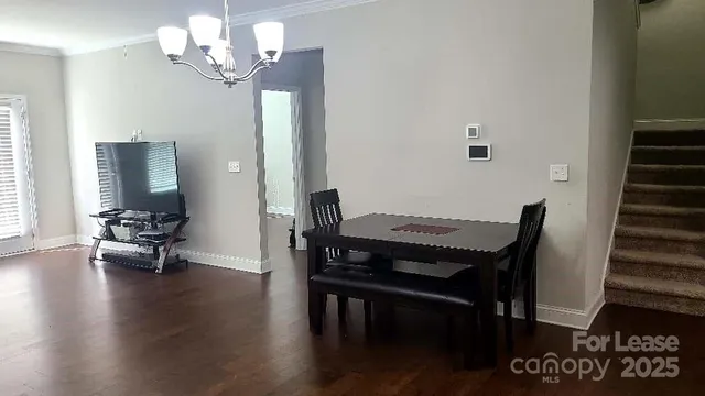 a view of a dining room with furniture wooden floor and a chandelier