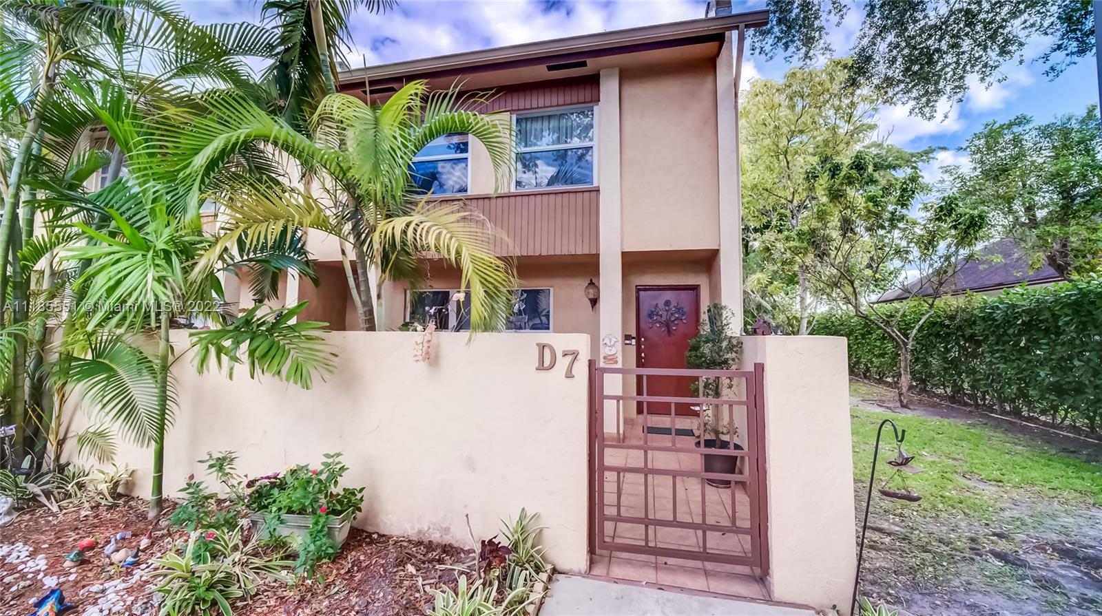14107 Southwest 66th Street, Unit D7 Miami, FL 33183 - Photo 1 of 38 front view of a house with a small yard
