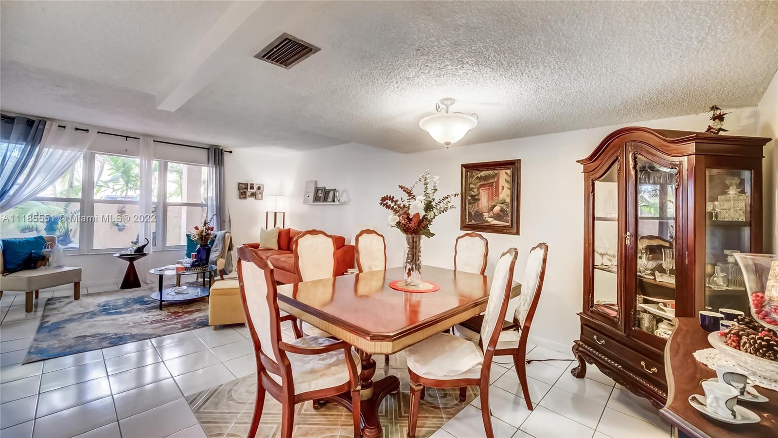 14107 Southwest 66th Street, Unit D7 Miami, FL 33183 - Photo 12 of 38 a dining room with furniture and window