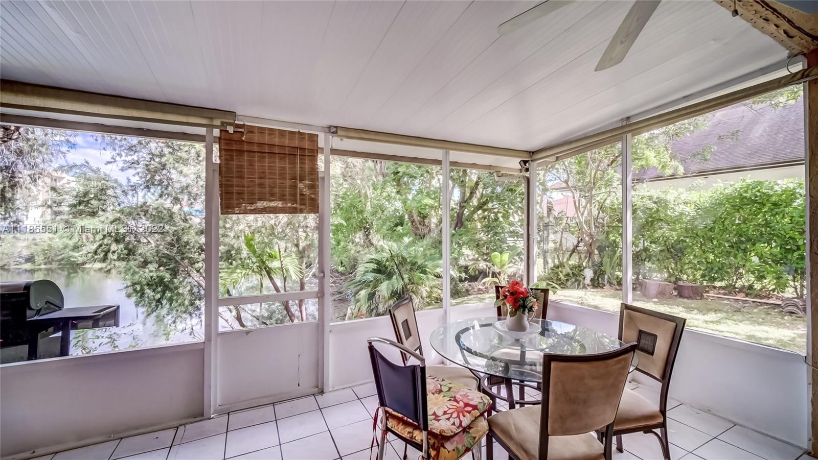 14107 Southwest 66th Street, Unit D7 Miami, FL 33183 - Photo 16 of 38 a dining room with furniture large windows and wooden floor