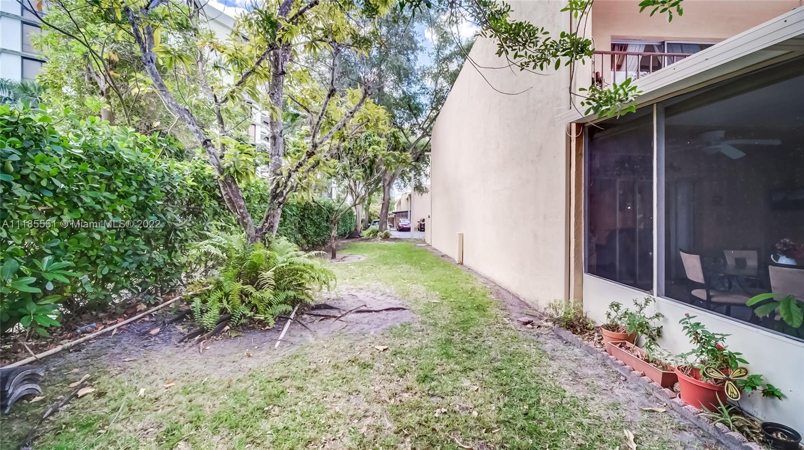14107 Southwest 66th Street, Unit D7 Miami, FL 33183 - Photo 20 of 38 a view of a yard with plants and a potted plant