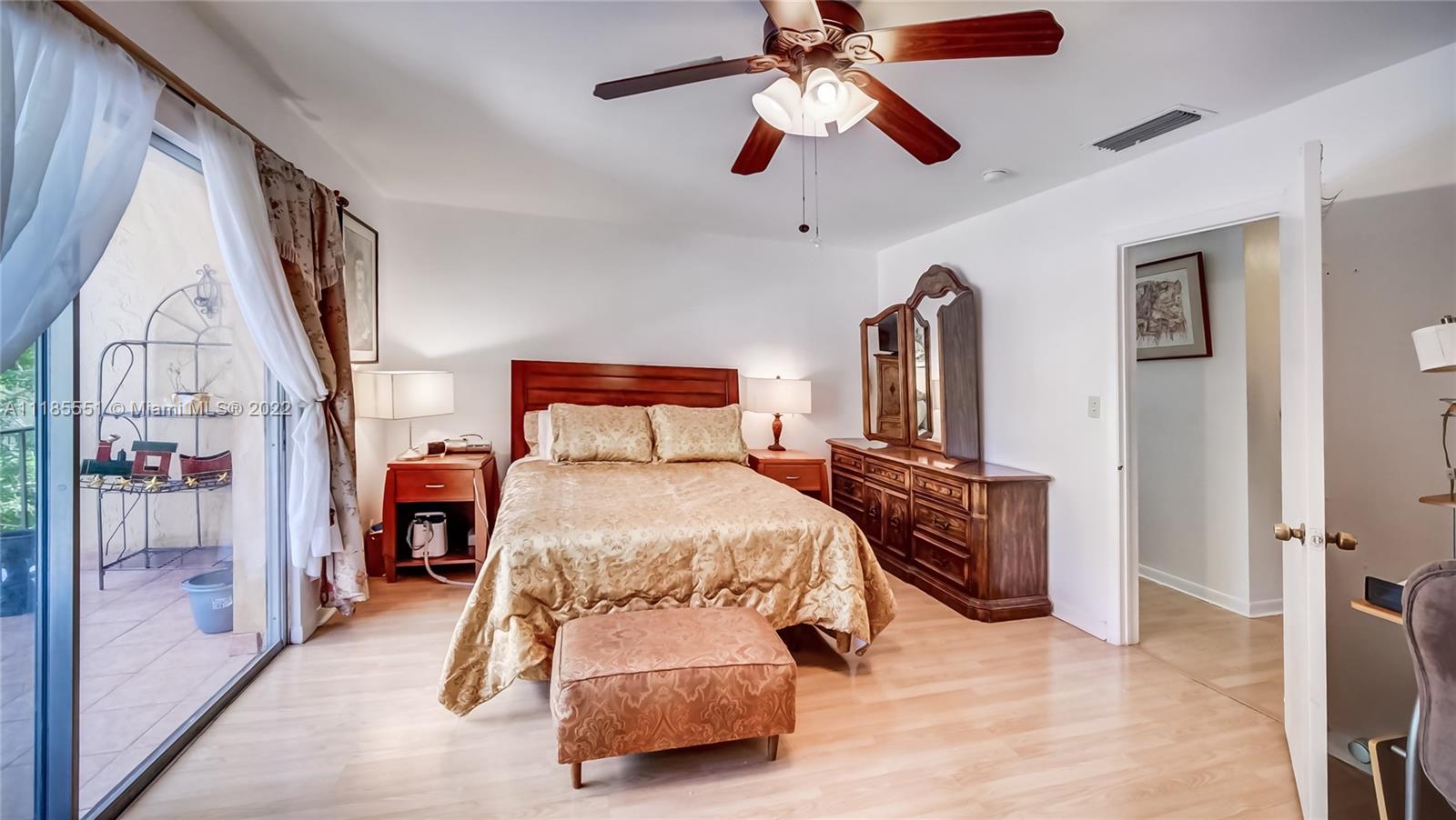 14107 Southwest 66th Street, Unit D7 Miami, FL 33183 - Photo 21 of 38 a bedroom with a bed and a chandelier