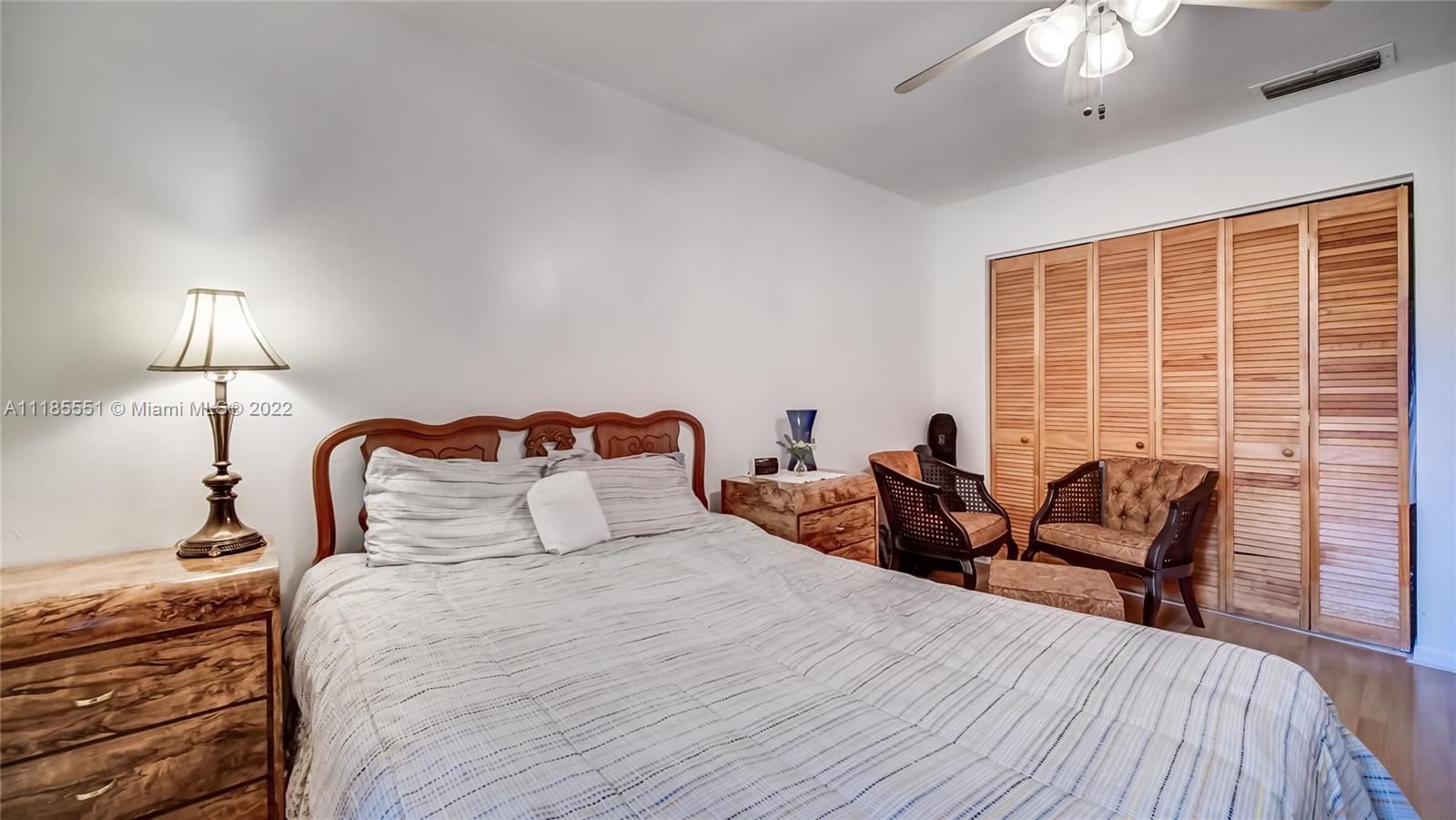 14107 Southwest 66th Street, Unit D7 Miami, FL 33183 - Photo 24 of 38 a bedroom with bed and a large window