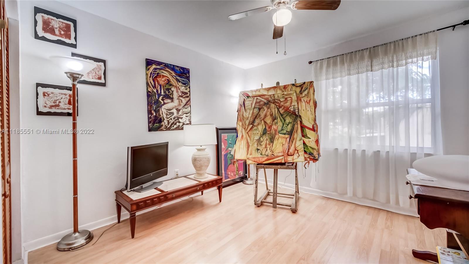 14107 Southwest 66th Street, Unit D7 Miami, FL 33183 - Photo 25 of 38 a living room with furniture and a flat screen tv
