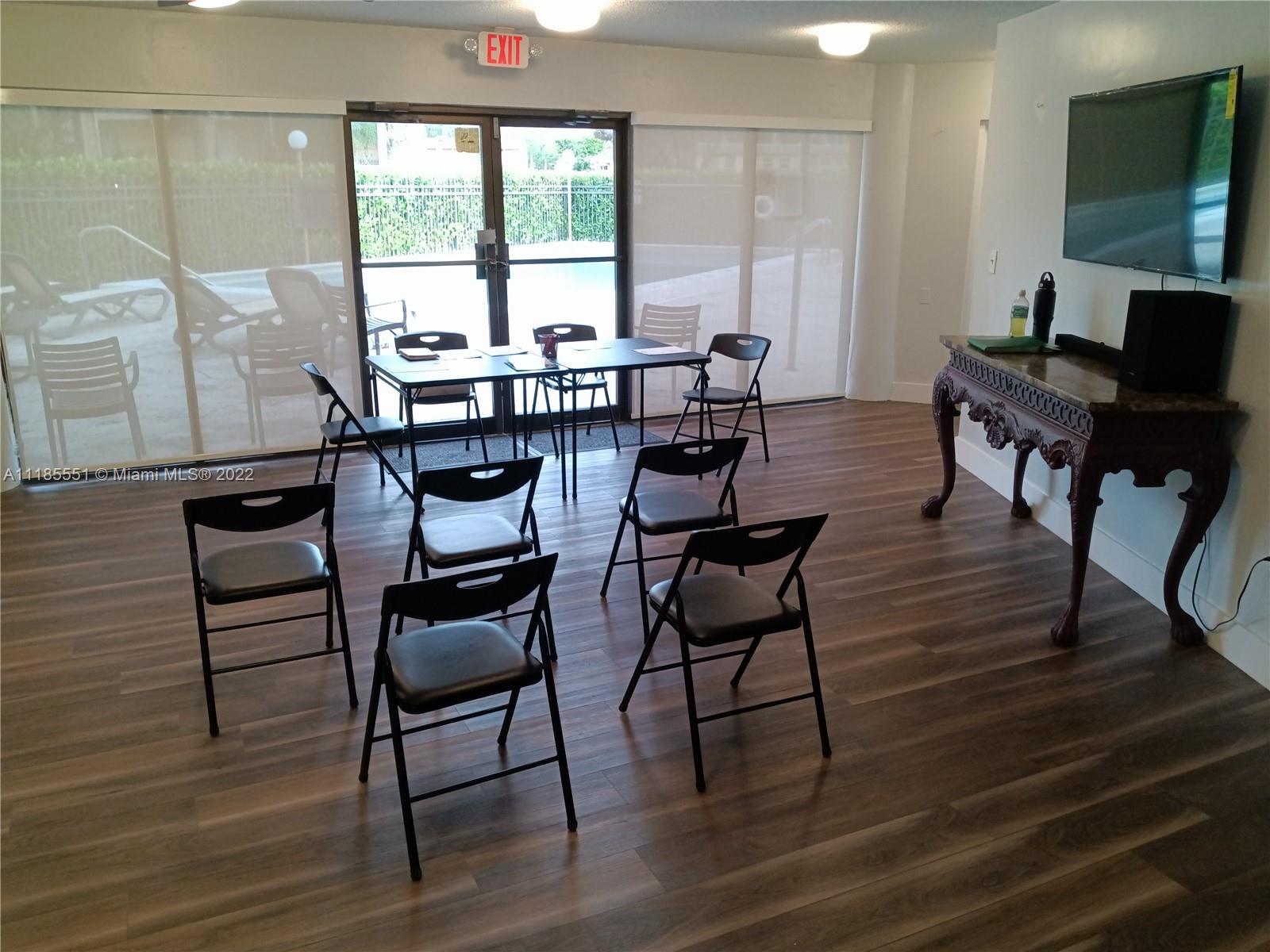 14107 Southwest 66th Street, Unit D7 Miami, FL 33183 - Photo 36 of 38 a view of a dining room with furniture and wooden floor