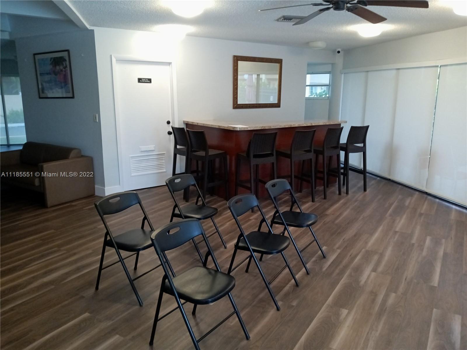 14107 Southwest 66th Street, Unit D7 Miami, FL 33183 - Photo 37 of 38 a view of a dining room with furniture and wooden floor