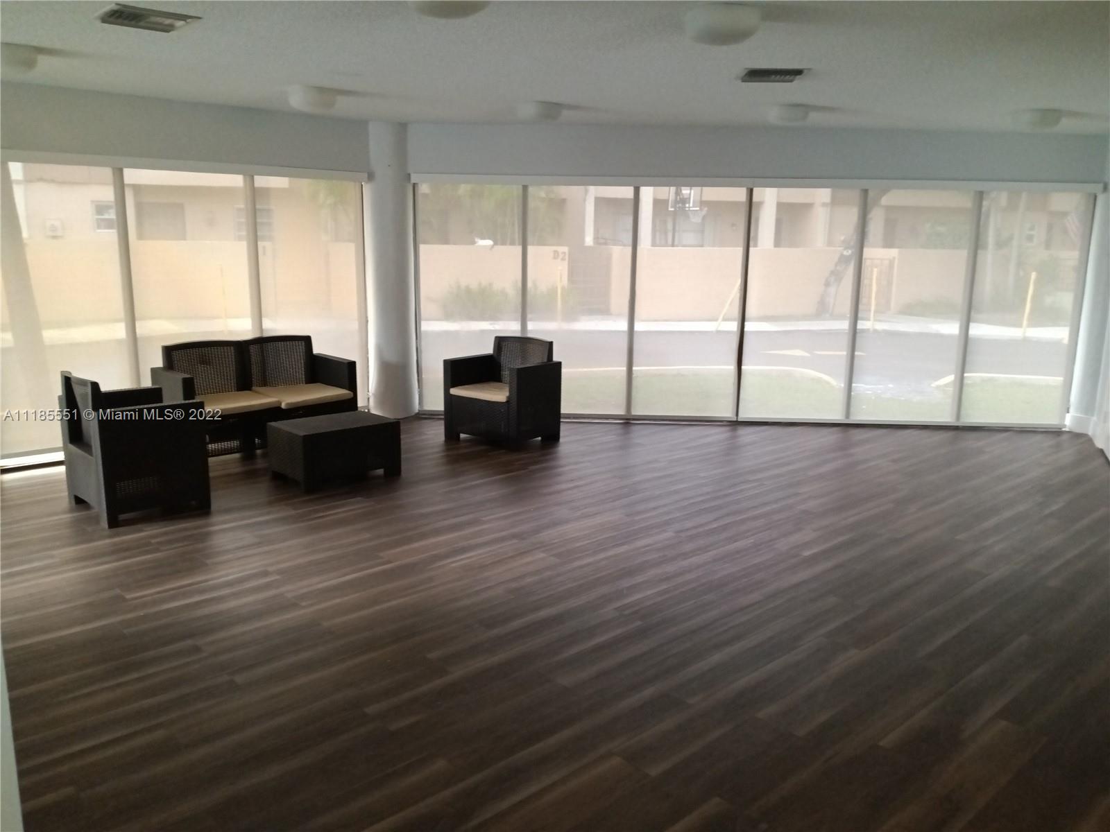 14107 Southwest 66th Street, Unit D7 Miami, FL 33183 - Photo 38 of 38 a living room with furniture and large windows