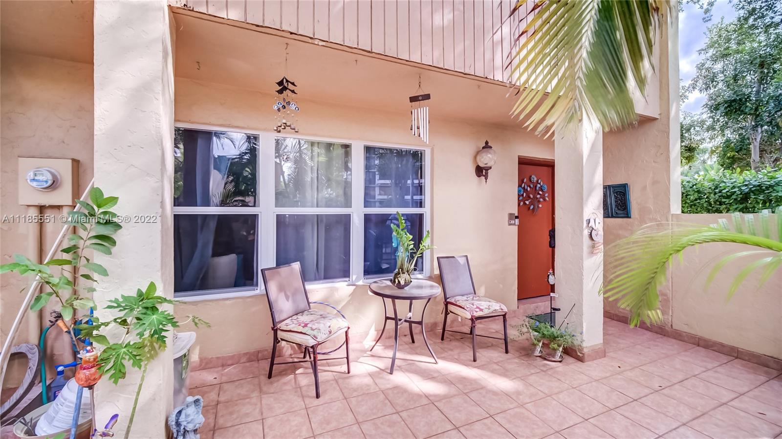 14107 Southwest 66th Street, Unit D7 Miami, FL 33183 - Photo 4 of 38 a view of a chairs and table in a patio