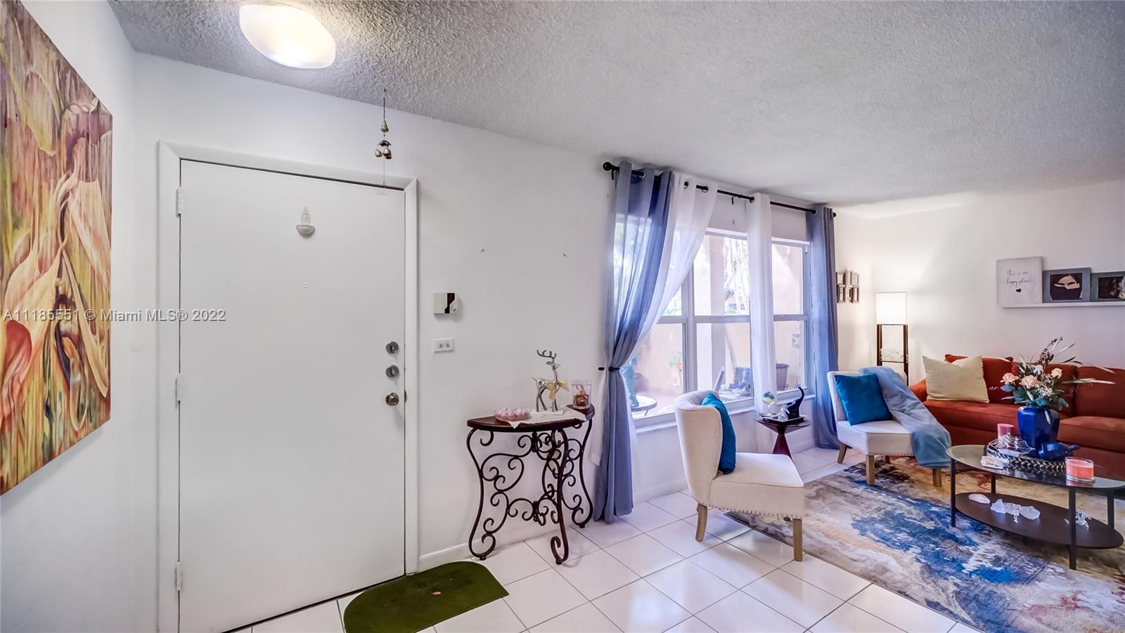 14107 Southwest 66th Street, Unit D7 Miami, FL 33183 - Photo 5 of 38 a living room with furniture and large windows
