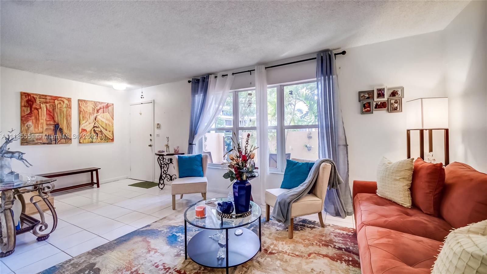 14107 Southwest 66th Street, Unit D7 Miami, FL 33183 - Photo 7 of 38 a living room with furniture and a large window