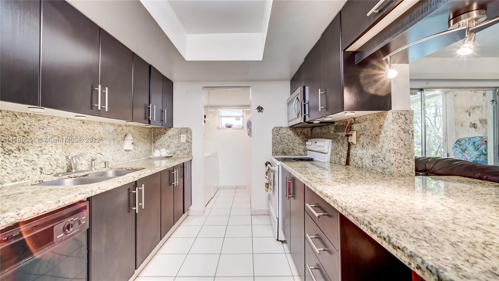 14107 Southwest 66th Street, Unit D7 Miami, FL 33183 - Photo 8 of 38 a kitchen with stainless steel appliances granite countertop a sink stove and cabinets