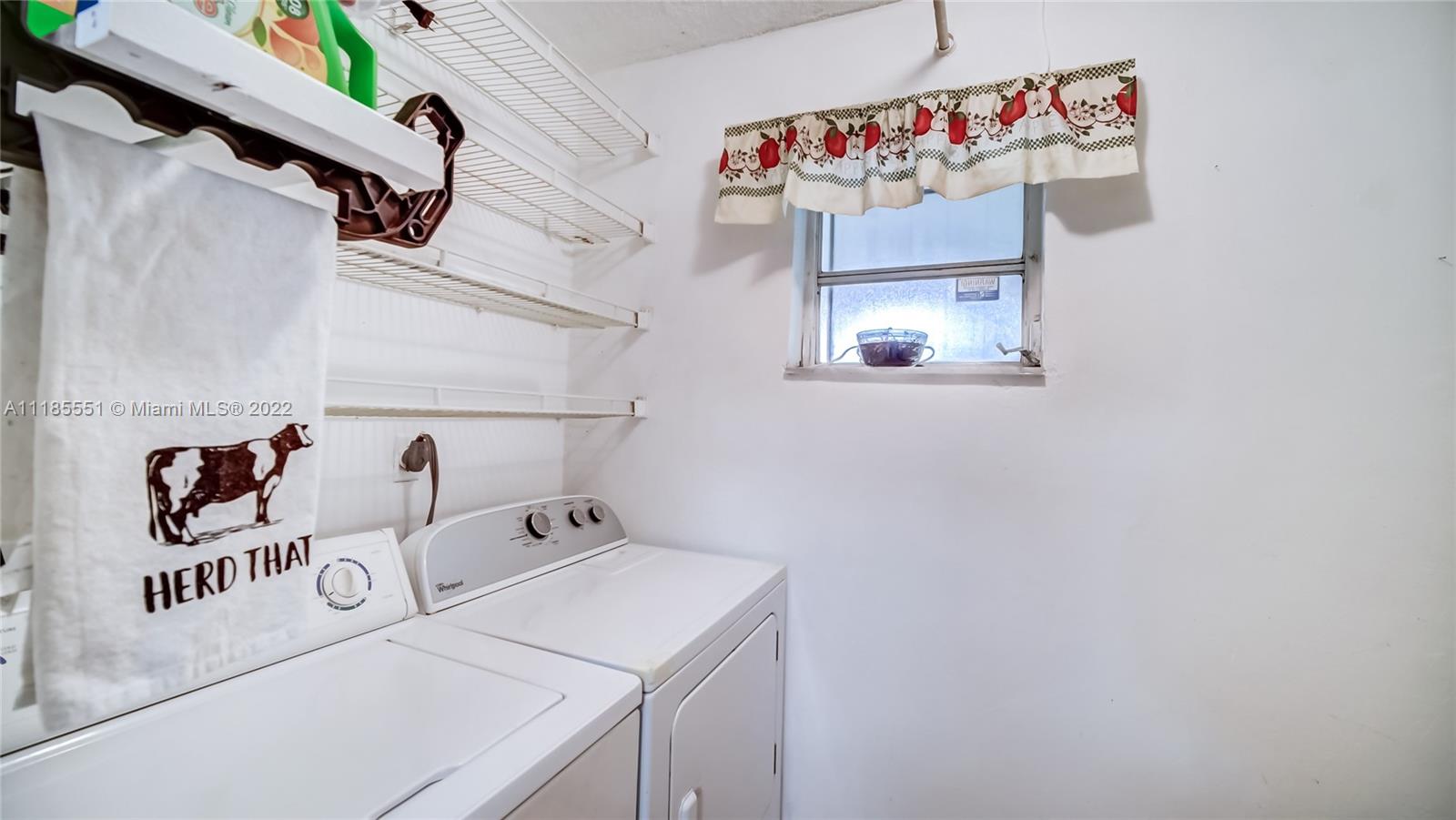 14107 Southwest 66th Street, Unit D7 Miami, FL 33183 - Photo 10 of 38 a utility room with a refrigerator a washer and dryer