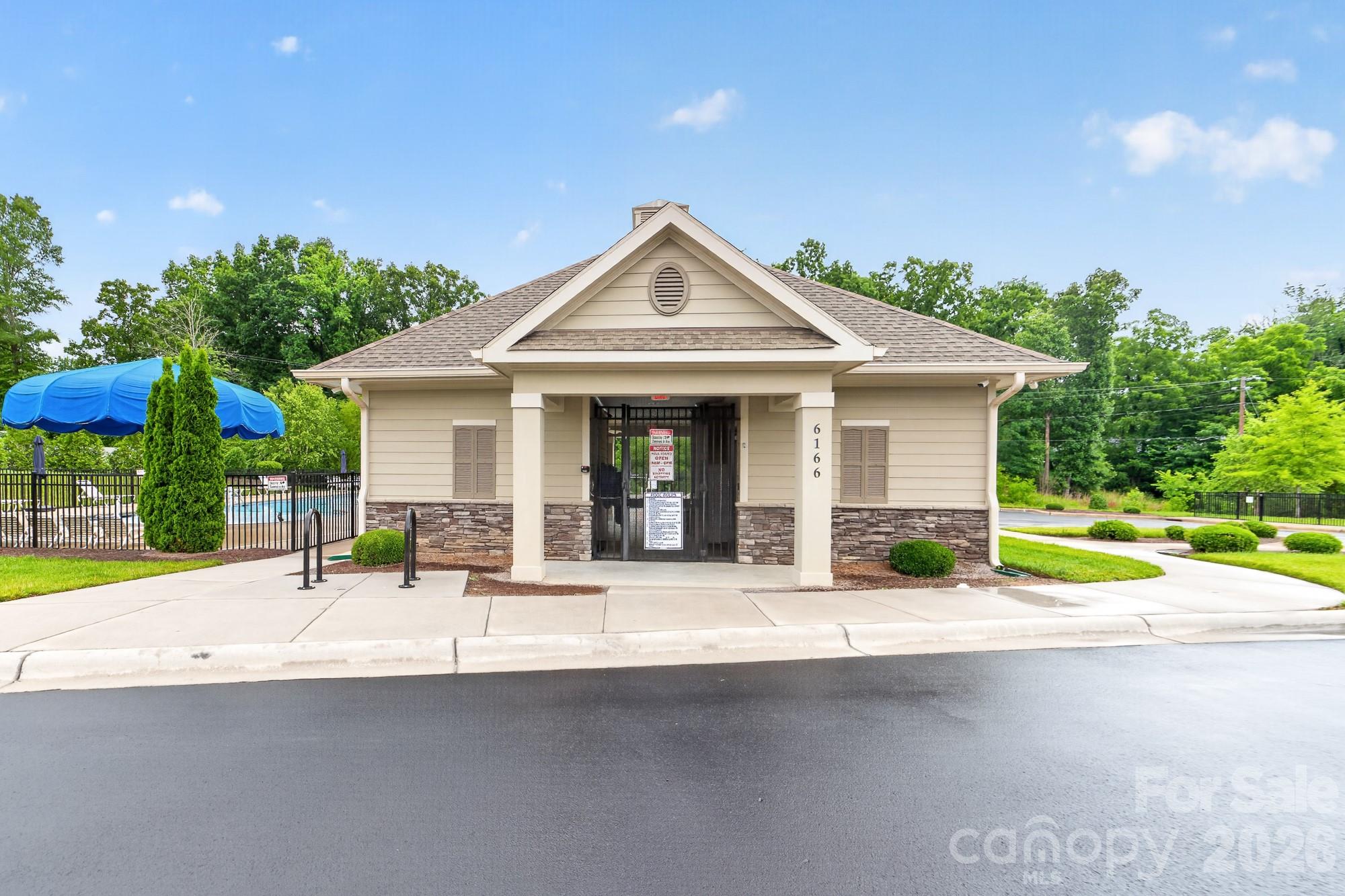 5972 Redwood Pine Road Concord, NC 28027 - Photo 34 of 37 a house with a yard and table in front of it
