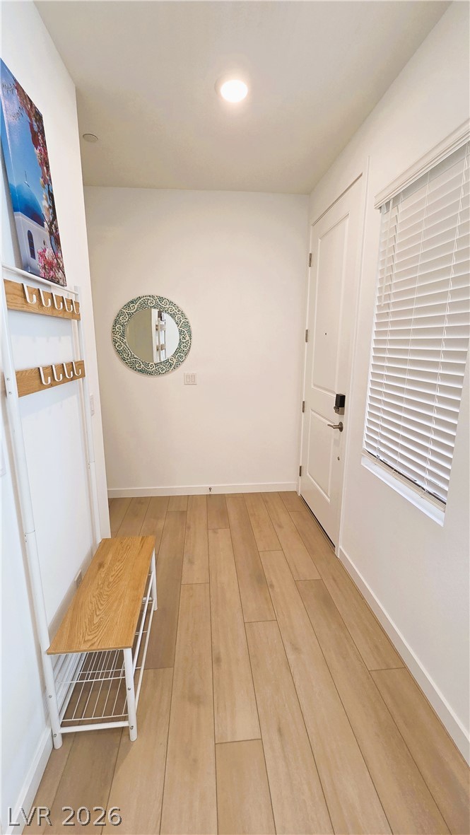 509 Arthur Pointe Street Henderson, NV 89011 - Photo 12 of 12 Enter into a streamlined entryway featuring warm wood flooring and a modern design.