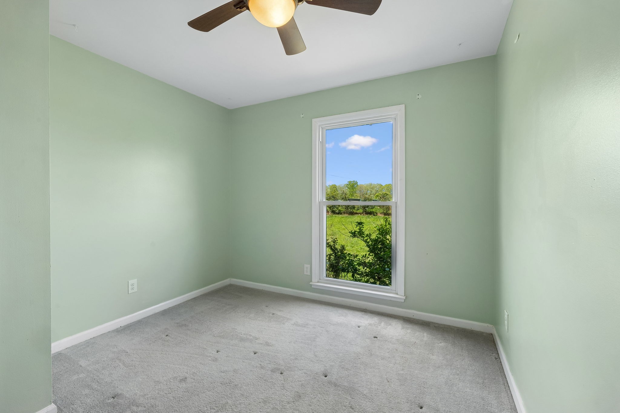 771 Mt Pleasant Road Kingston Springs, TN 37082 - Photo 13 of 31 an empty room with a window and a ceiling fan