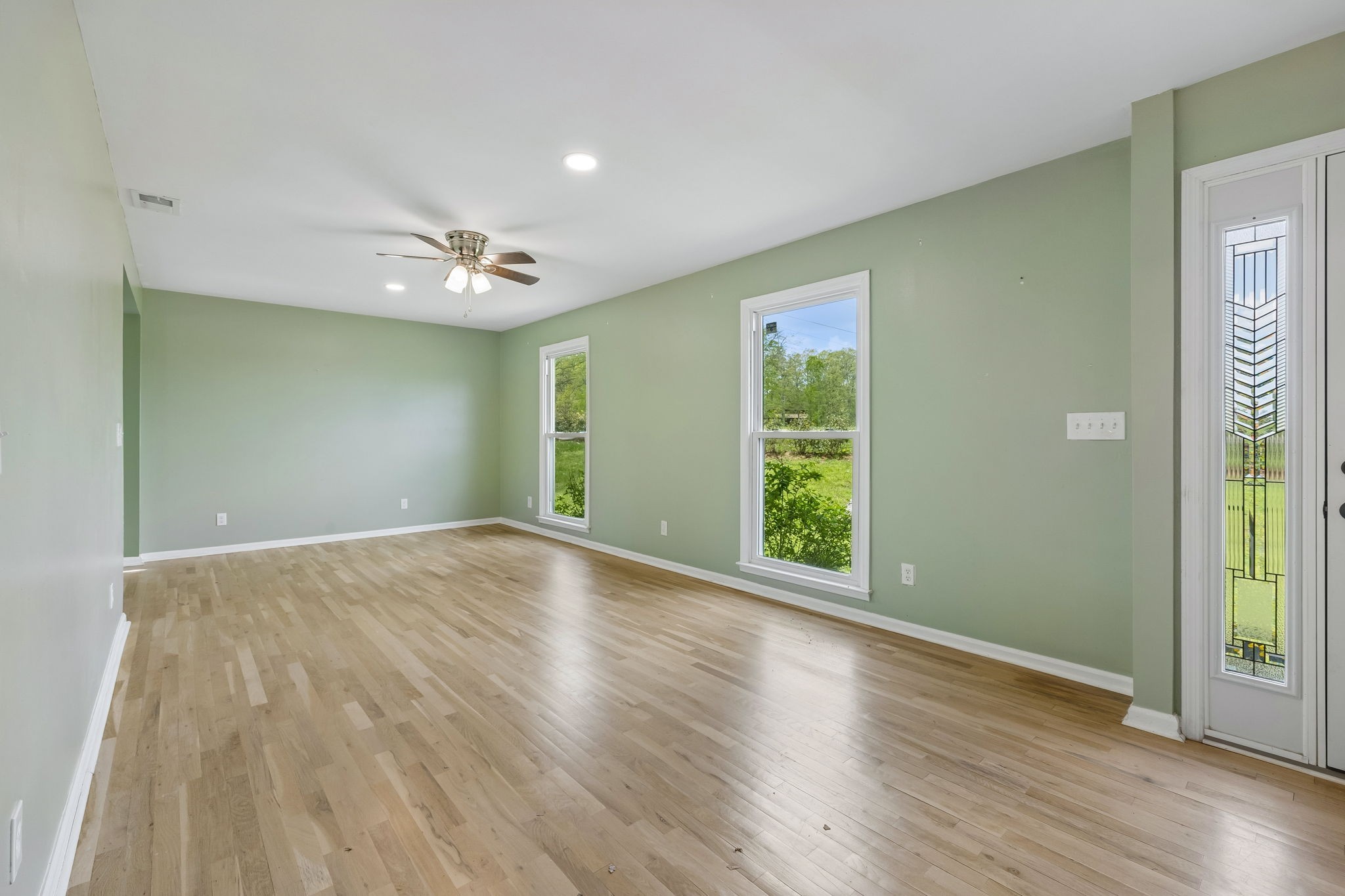 771 Mt Pleasant Road Kingston Springs, TN 37082 - Photo 5 of 31 a view of an empty room with wooden floor and a window