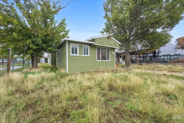 a front view of a house with yard and green space