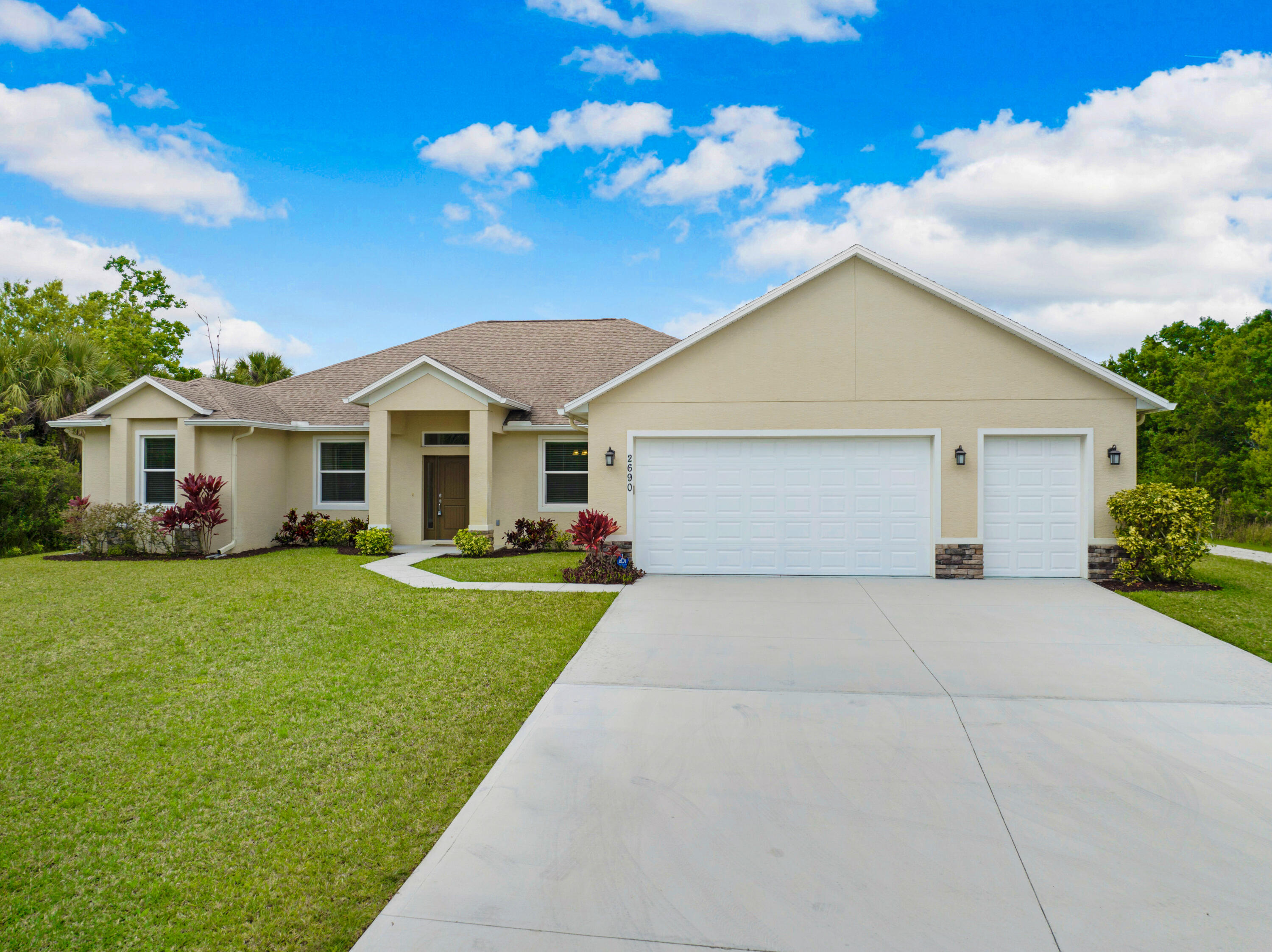 2690 Weber Road Malabar, FL 32950 - Photo 2 of 60 a front view of a house with a garden and yard