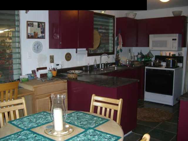 151 Kahiapo Place Haiku, HI 96708 - Photo 4 of 13 a kitchen with stainless steel appliances granite countertop a stove a sink and a microwave