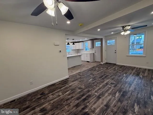a view of staircase with railing and white walls