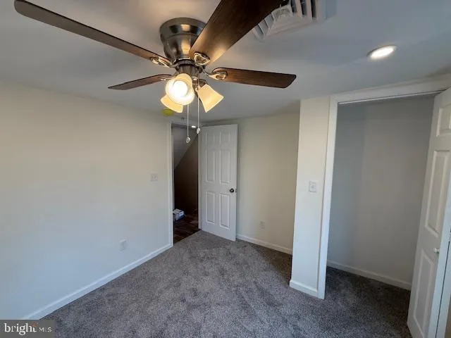 a bathroom with a toilet and mirror
