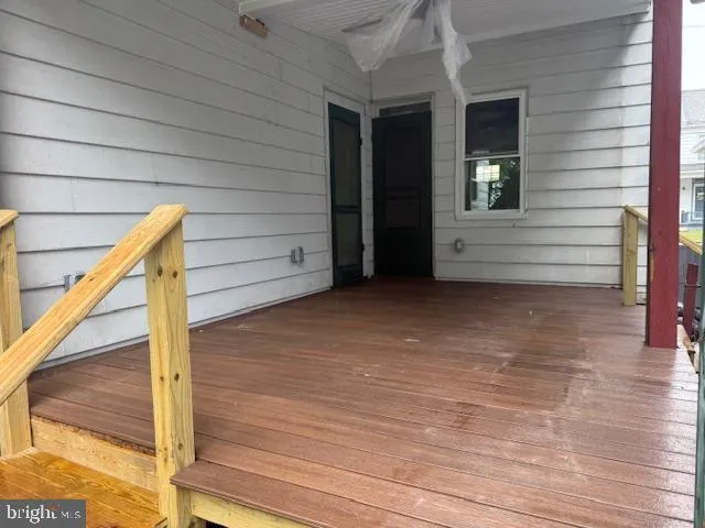 a view of a hallway with a dining table and chandelier