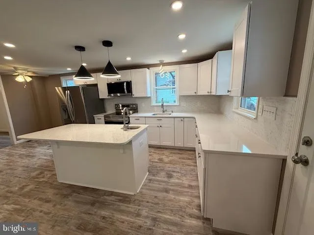 a kitchen with a sink a stove and cabinets