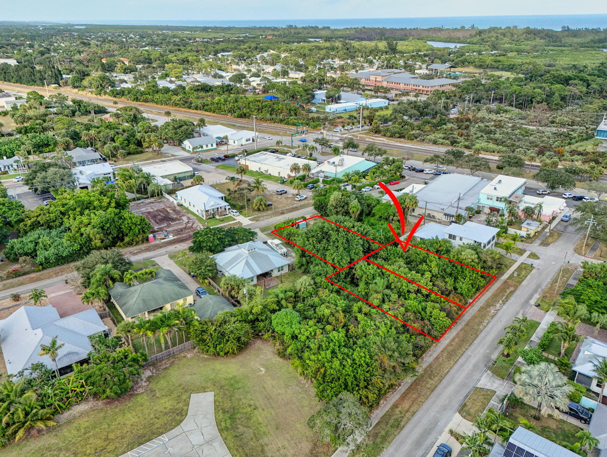 9156 Southeast Mars Street Hobe Sound, FL 33455 - Photo 11 of 25 an aerial view of residential houses with outdoor space and trees