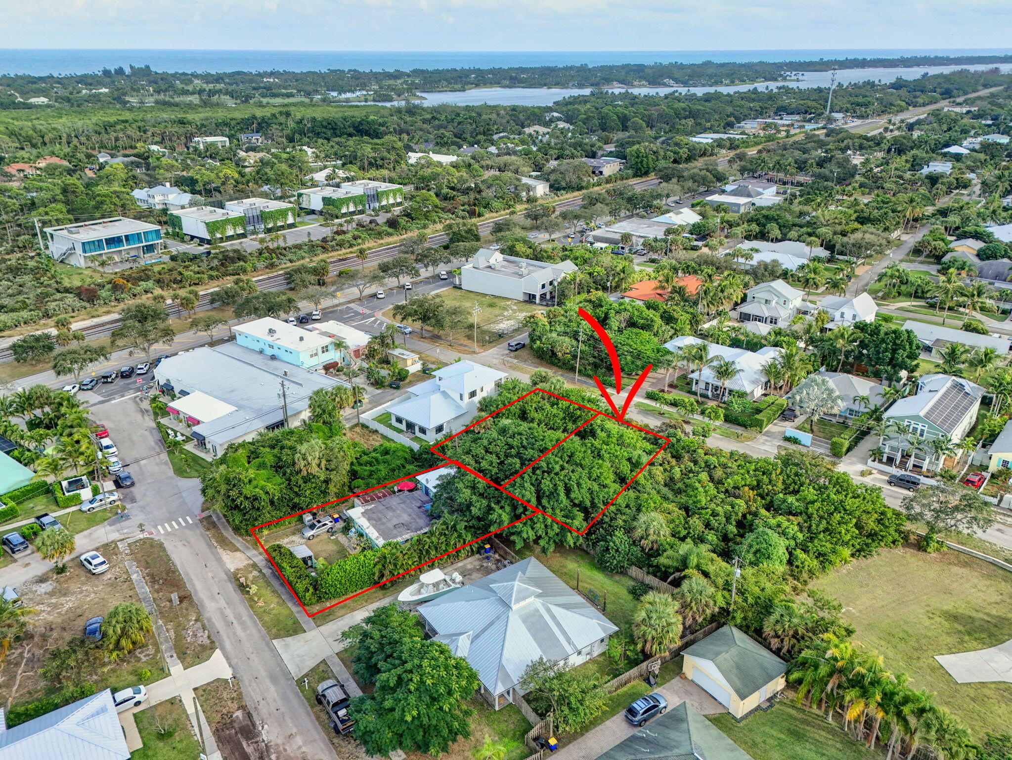 9156 Southeast Mars Street Hobe Sound, FL 33455 - Photo 4 of 25 an aerial view of residential houses with outdoor space and trees