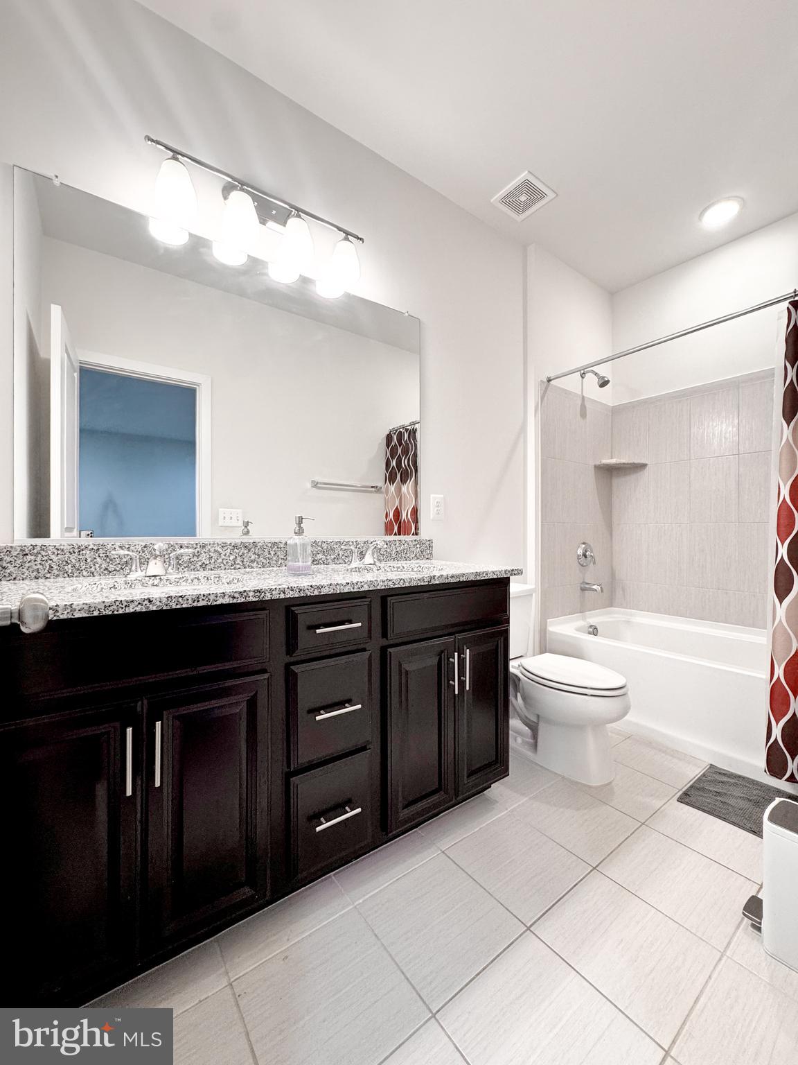 25419 Reed Orchard Terrace Chantilly, VA 20152 - Photo 12 of 47 a bathroom with a granite countertop sink toilet mirror and bathtub