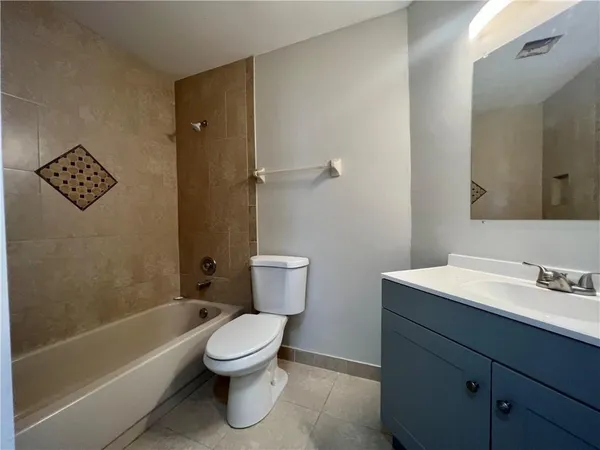 a bathroom with a toilet a sink and bathtub
