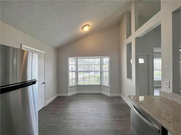a view of a kitchen cabinets and wooden floor