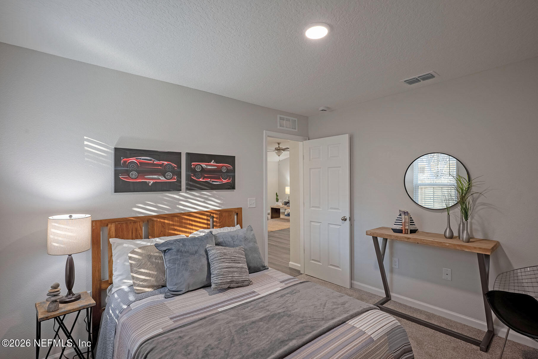 1639 Lakewood Road Jacksonville, FL 32207 - Photo 16 of 39 a bedroom with a bed and a lamp on dresser