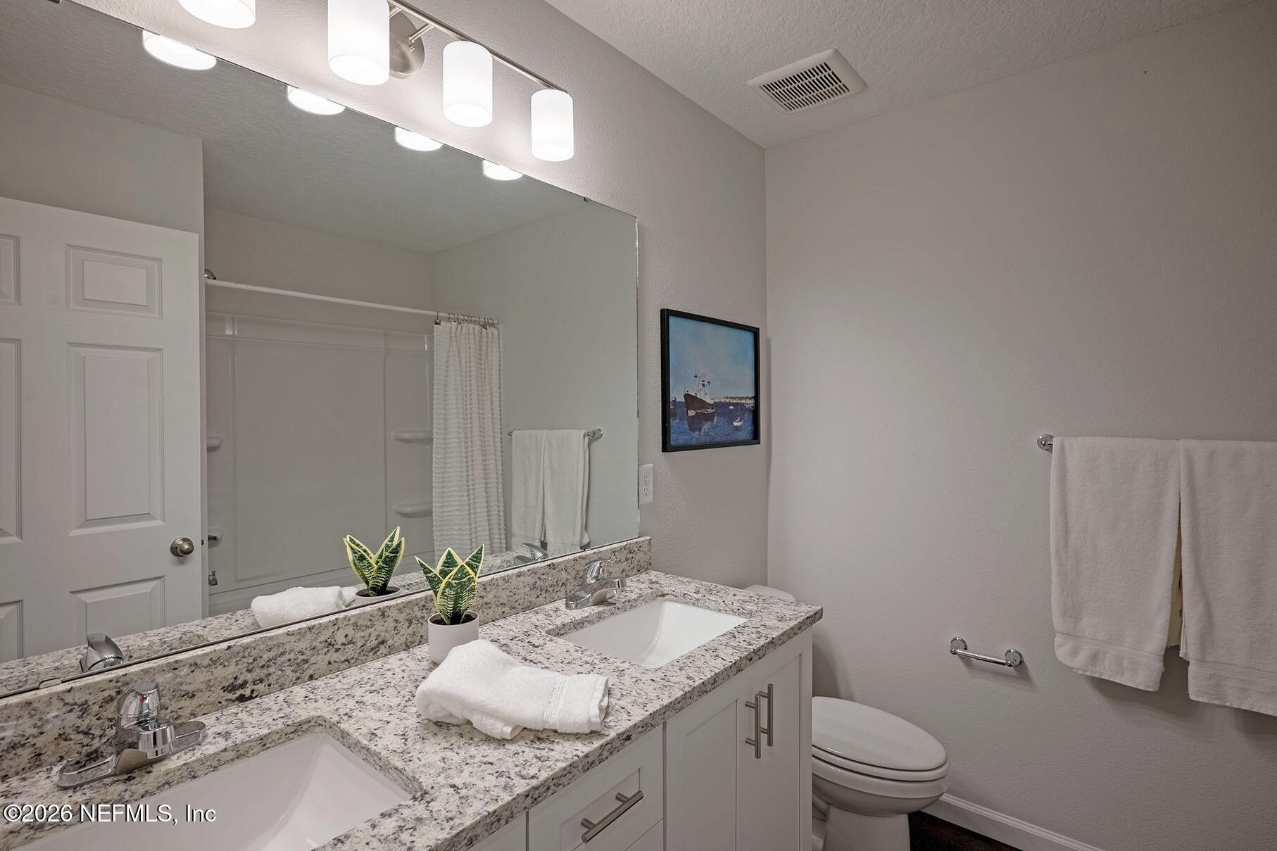 1639 Lakewood Road Jacksonville, FL 32207 - Photo 20 of 39 a bathroom with a granite countertop sink a toilet and mirror
