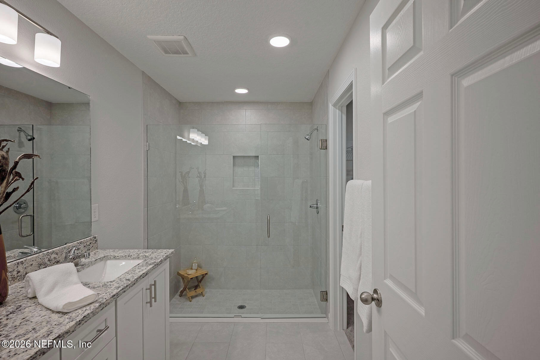 1639 Lakewood Road Jacksonville, FL 32207 - Photo 32 of 39 a bathroom with a granite countertop sink a mirror and a bathtub