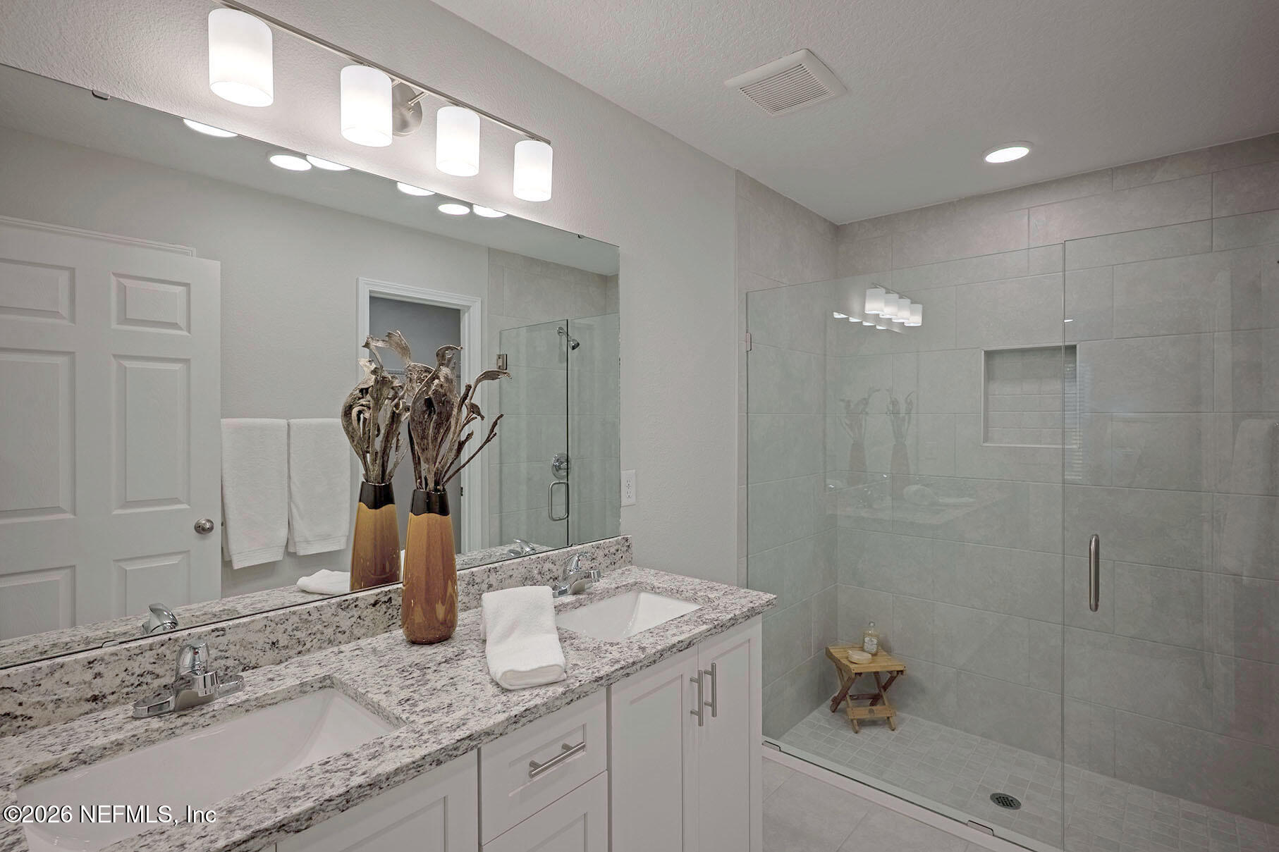 1639 Lakewood Road Jacksonville, FL 32207 - Photo 33 of 39 a bathroom with a granite countertop sink a mirror and shower
