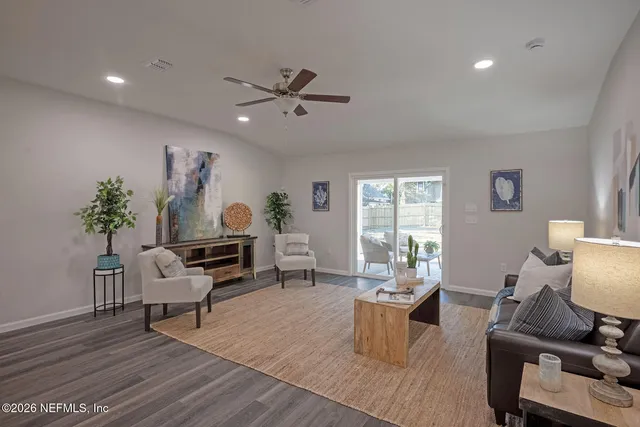 a living room with furniture and a potted plant